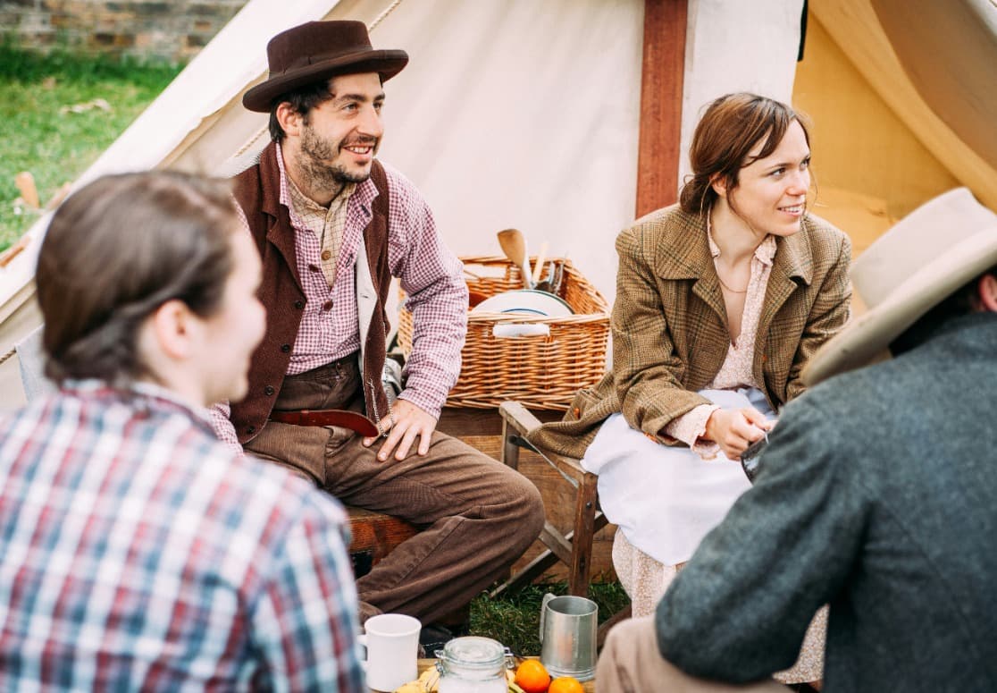Outdoor meeting with people around a rustic table